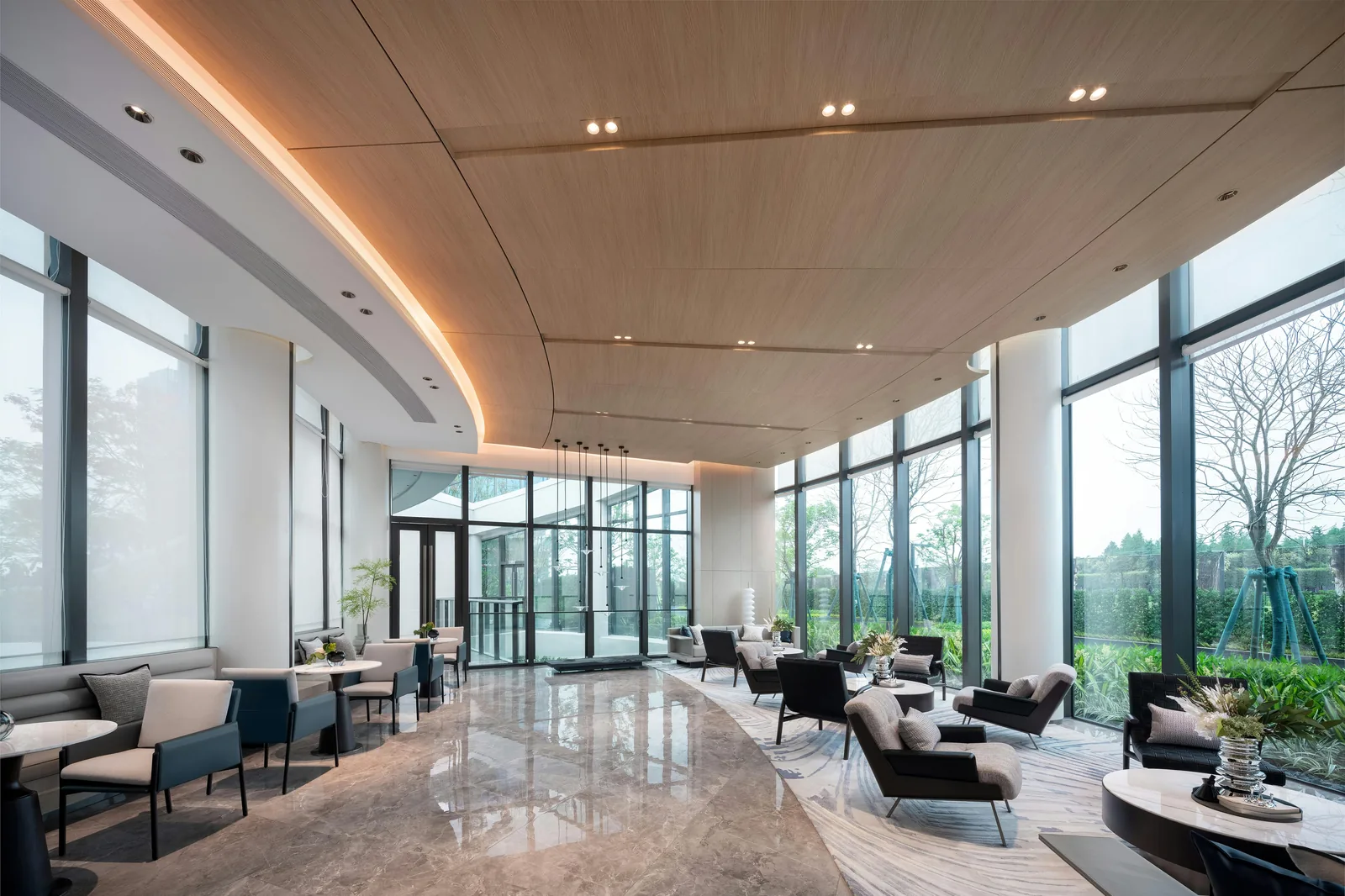Sunlit luxury hotel lobby with polished finishes.